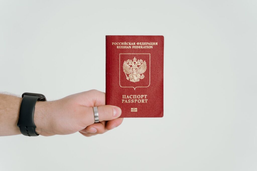 pexels-photo-7010095 Close-up of a hand holding a Russian Federation passport.